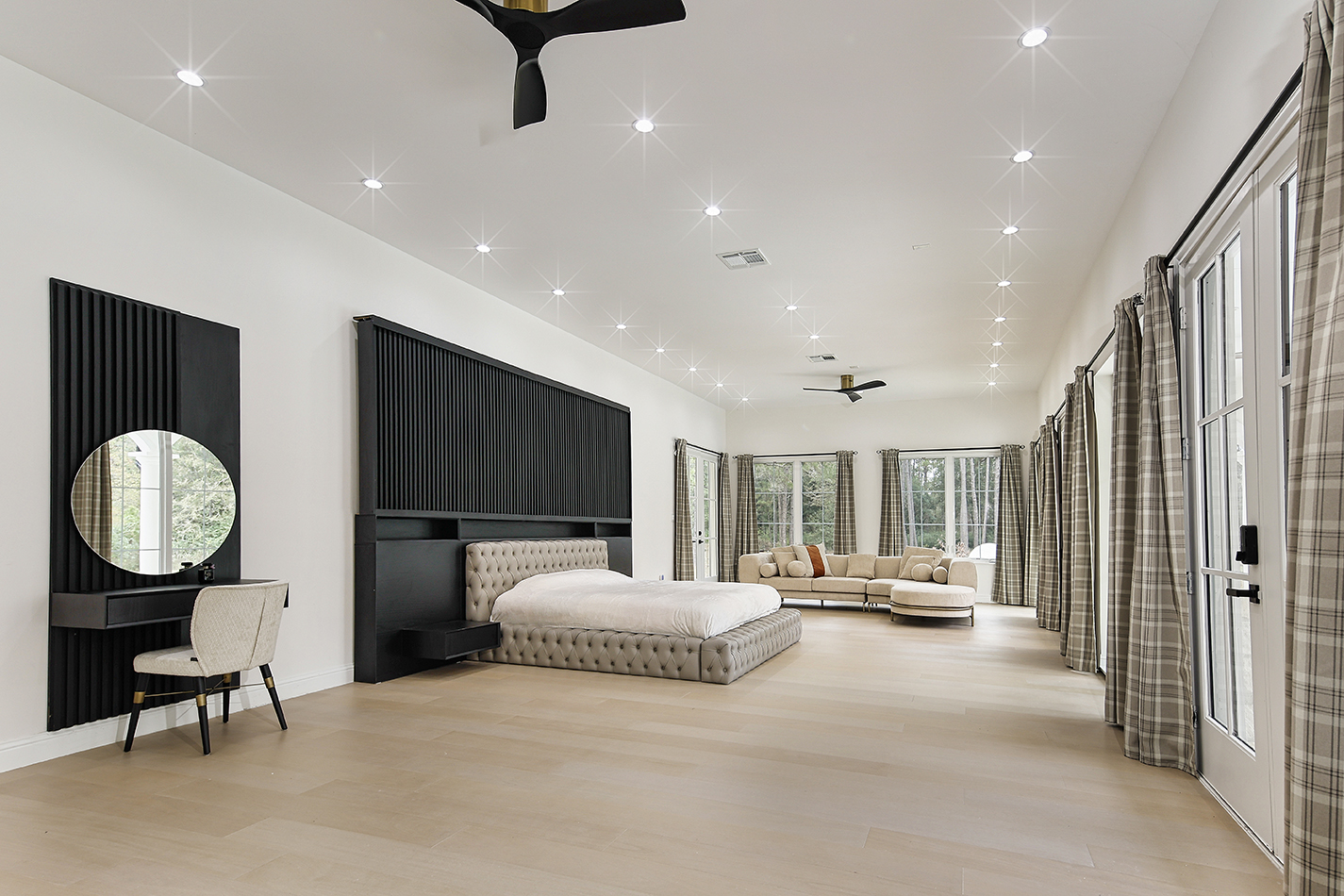 Expansive primary suite with sitting area and garden doors