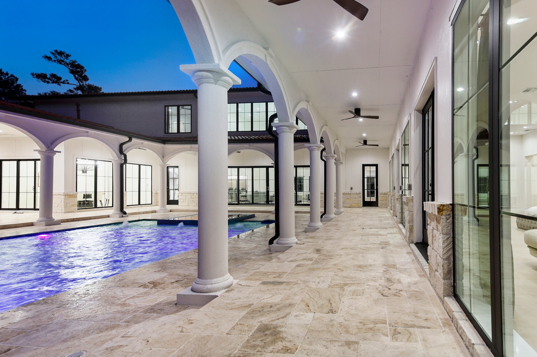 Courtyard pool and colonnade at dusk