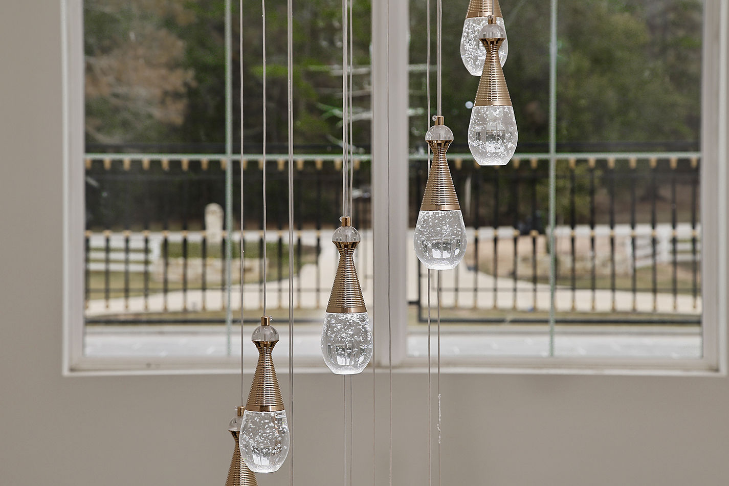 Crystal and brass pendant detail above the entry